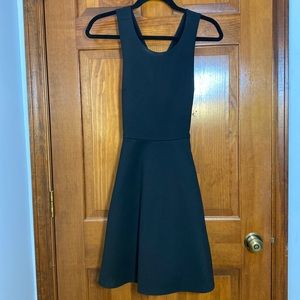 Black A-line dress with crossed straps in back